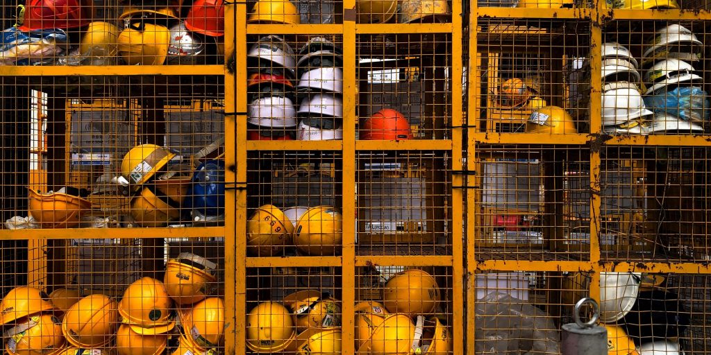 hard hats on a shelf