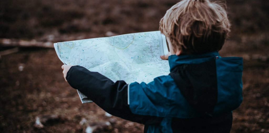 child reading map