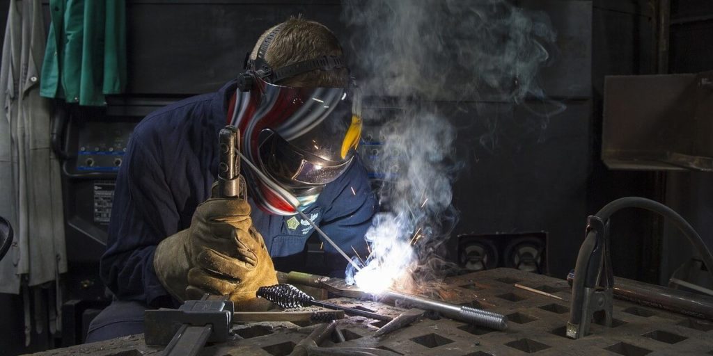 worker welding a pipe