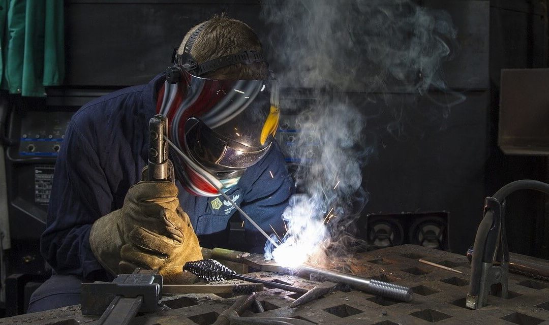 worker welding a pipe