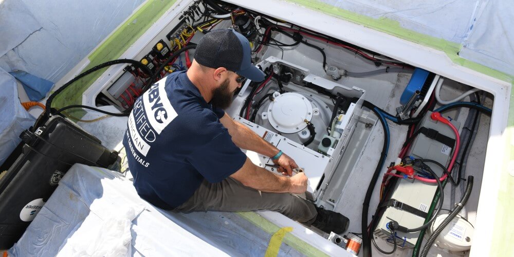 marine technician working on a boat motor