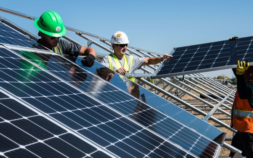 workers installing solar panels