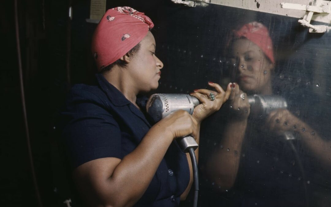 A woman operating a hand drill while working on a “Vengeance” dive bomber in Nashville, Tennessee, 1943. Library of Congress.