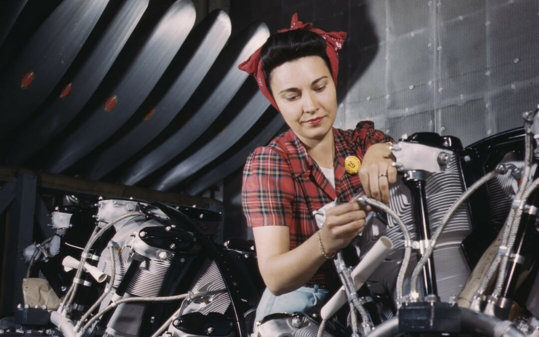 A woman working on an airplane motor at the North American Aviation, Inc, plant in Inglewood, California, 1942. Library of Congress.