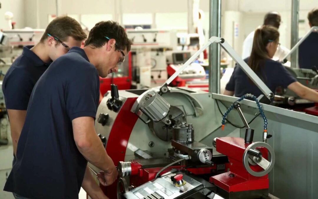 two apprentices in a machine shop