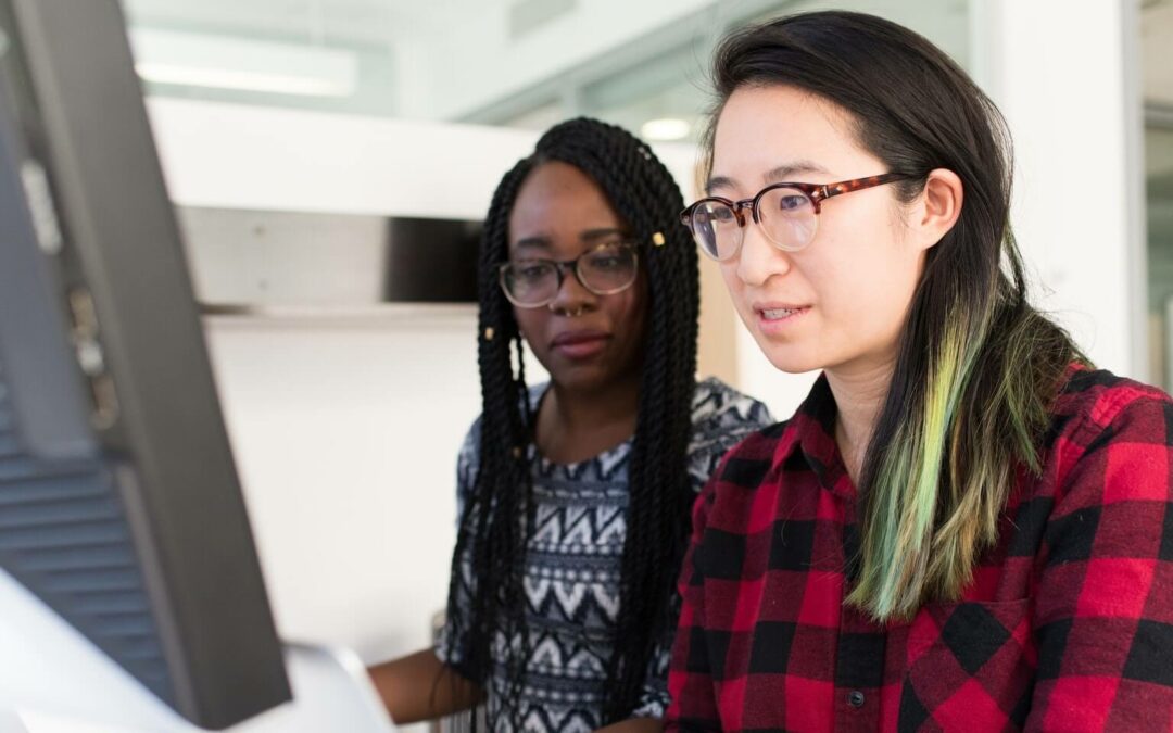 two people working together on a computer