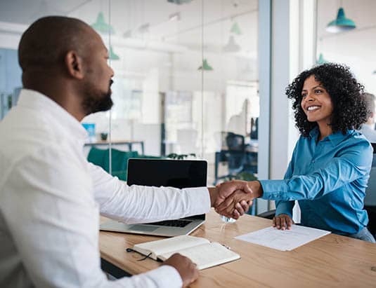 manager shaking hand of new hire